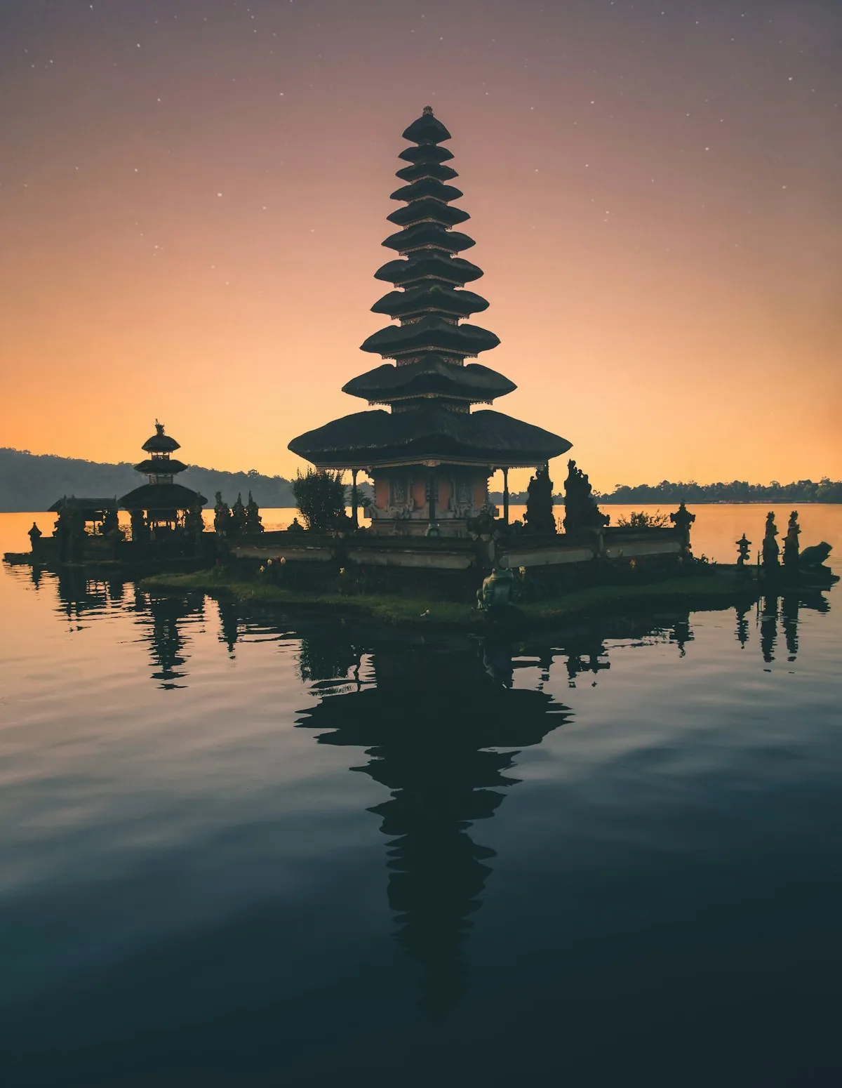 Pura Ulun Danu Beratan silhouetted against a sunset over Lake Beratan, Bali